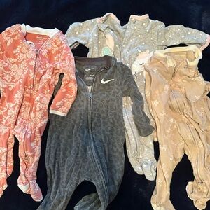 Lot of four 0-3 month size sleepers: Nike, Burt’s Bees x2, Carters